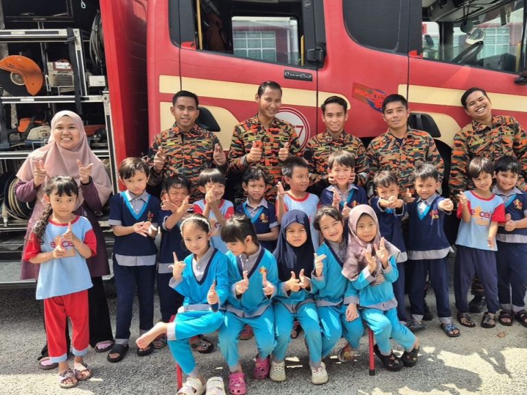 Excel Kids children and teachers with firefighters beside a fire engine
